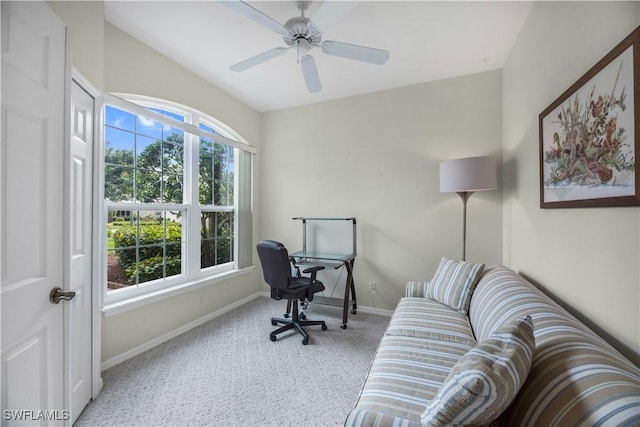 home office featuring ceiling fan, light colored carpet, and baseboards