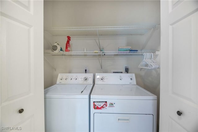 clothes washing area featuring laundry area and washer and dryer