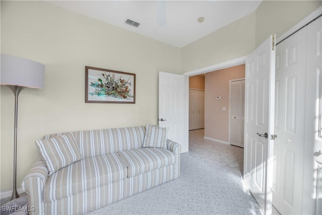 living room featuring baseboards and visible vents