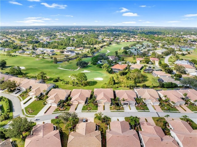 drone / aerial view featuring view of golf course and a residential view