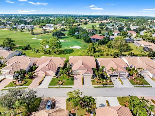 drone / aerial view featuring golf course view and a residential view