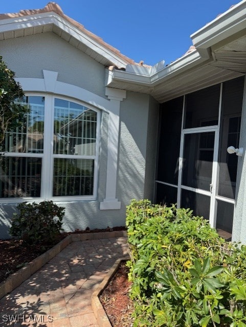 doorway to property with stucco siding