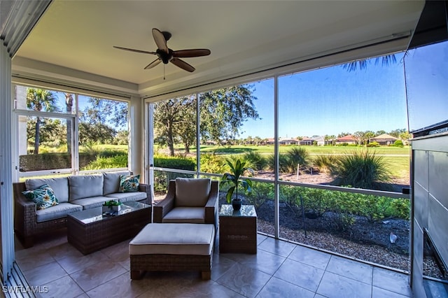 sunroom featuring a ceiling fan