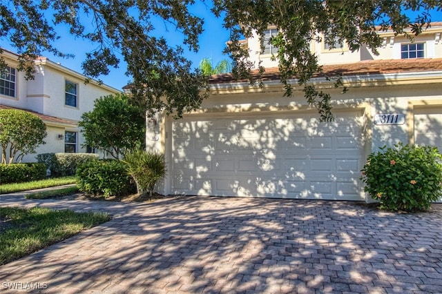 garage with decorative driveway