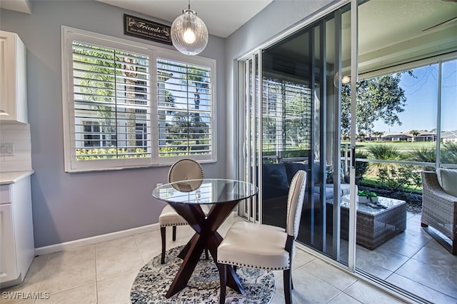 dining area with baseboards and light tile patterned flooring