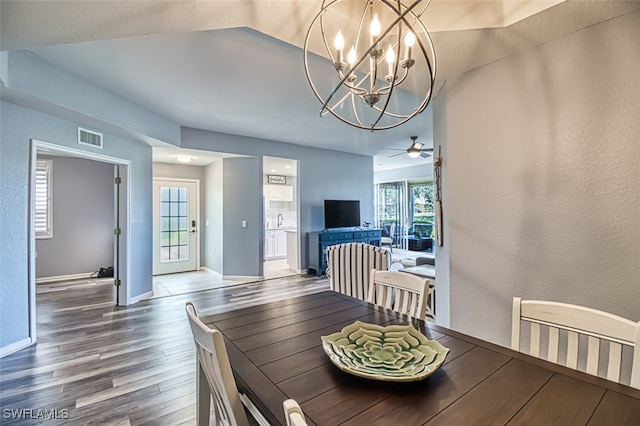 3111 Meandering Way Unit 101, Fort Myers, FL 33905 - dining area with wood finished floors, a chandelier, a ceiling fan, baseboards, and lofted ceiling