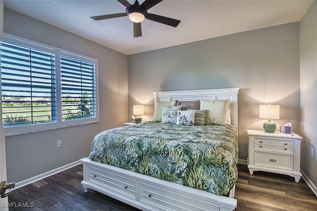 bedroom featuring a ceiling fan, baseboards, and dark wood-type flooring