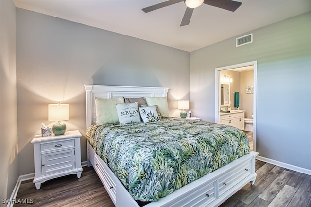 bedroom featuring dark wood-style flooring, ensuite bath, visible vents, and baseboards