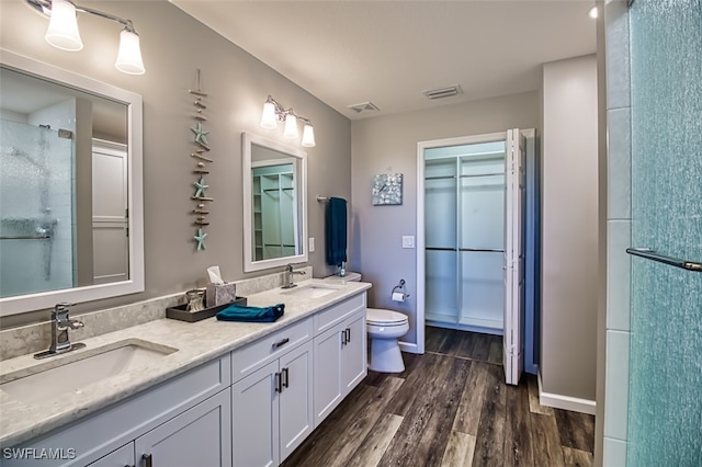 full bathroom featuring visible vents, a sink, and wood finished floors