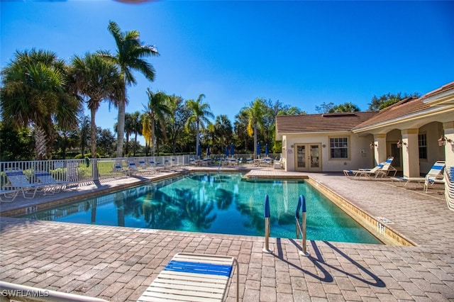 pool featuring a patio area and fence