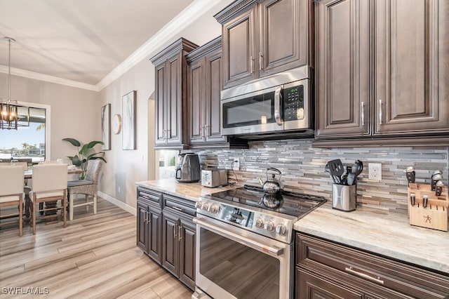 kitchen featuring stainless steel appliances, dark brown cabinets, hanging light fixtures, tasteful backsplash, and crown molding