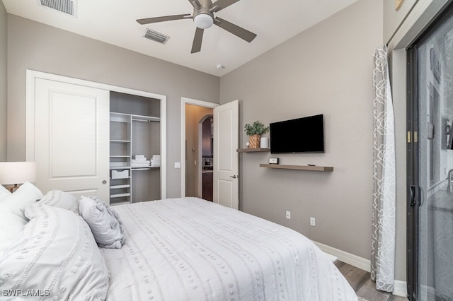 bedroom with a ceiling fan, a closet, visible vents, and wood finished floors