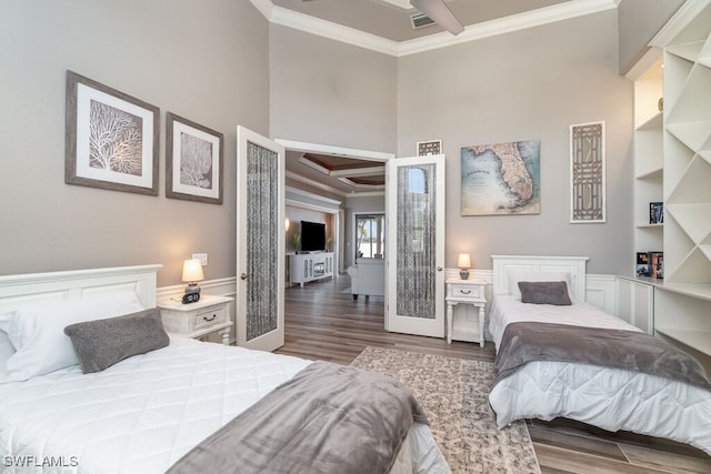 bedroom featuring visible vents, ornamental molding, and wood finished floors