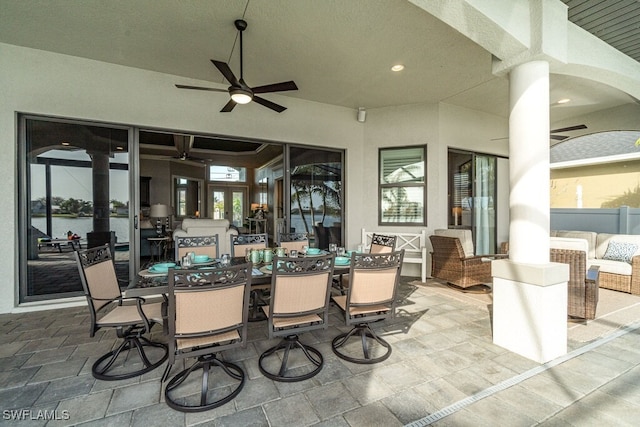 view of patio with outdoor dining area and ceiling fan