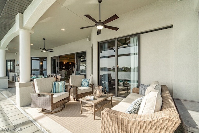 view of patio featuring outdoor dining space, a water view, ceiling fan, and an outdoor hangout area