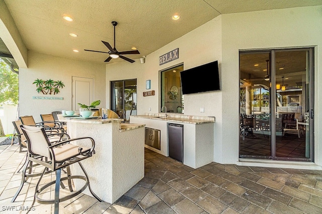 view of patio featuring ceiling fan