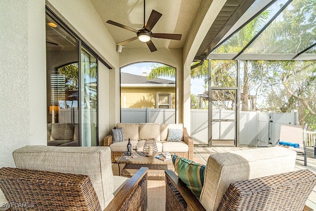 sunroom featuring ceiling fan