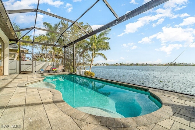 pool featuring glass enclosure, a patio, and a water view