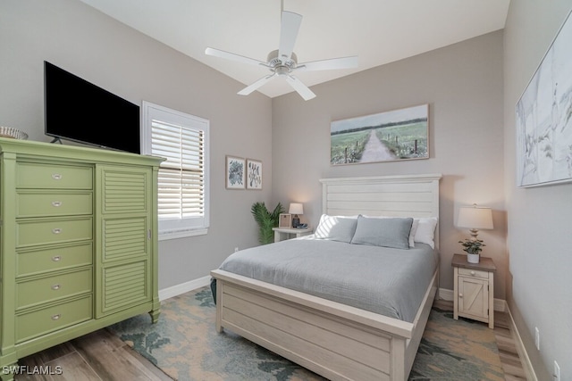 bedroom with dark wood-style floors, baseboards, and a ceiling fan