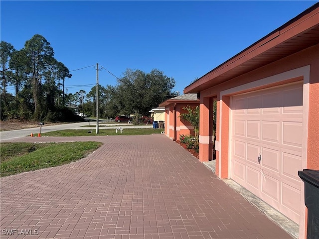 garage featuring decorative driveway