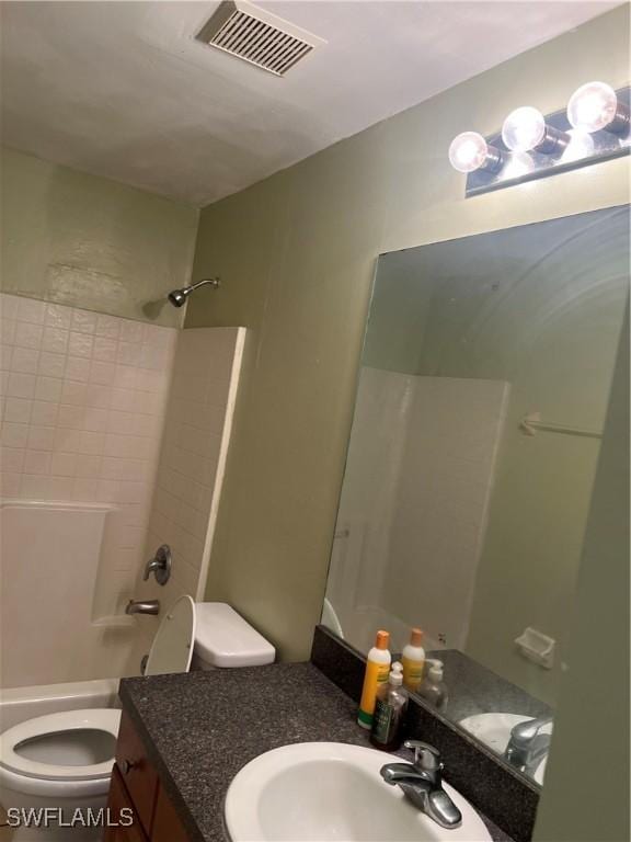 bathroom featuring toilet, bathtub / shower combination, visible vents, and vanity