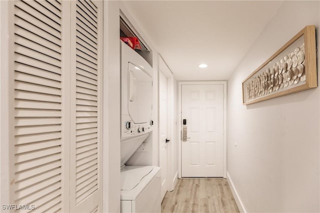 washroom with recessed lighting, laundry area, stacked washer / dryer, baseboards, and light wood-type flooring