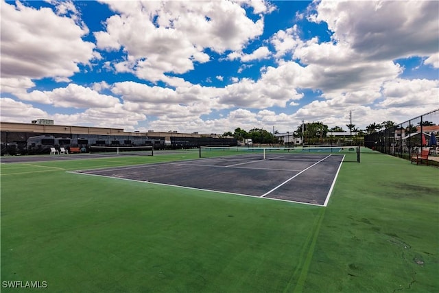 view of tennis court featuring fence