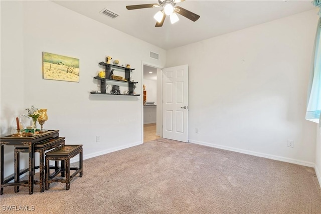 empty room featuring light colored carpet, visible vents, and baseboards