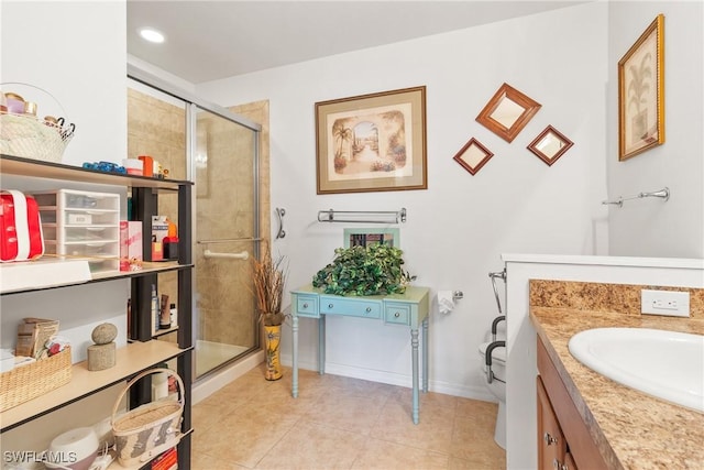 full bath featuring a stall shower, tile patterned flooring, vanity, and baseboards