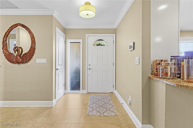 foyer entrance featuring baseboards, visible vents, crown molding, and light tile patterned flooring