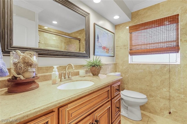 full bath with toilet, vanity, tile walls, ornamental molding, and tile patterned floors