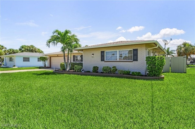 ranch-style house featuring an attached garage, brick siding, driveway, a gate, and a front yard