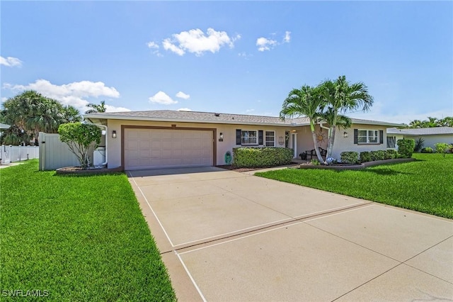 single story home featuring stucco siding, concrete driveway, an attached garage, a front yard, and fence