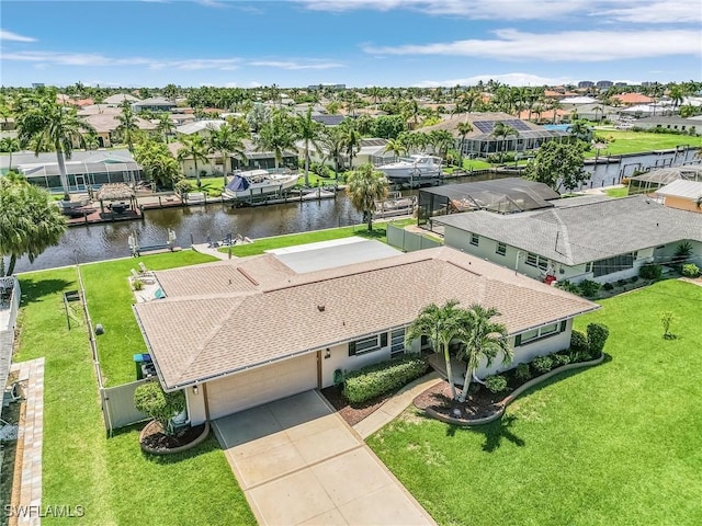 drone / aerial view featuring a water view and a residential view