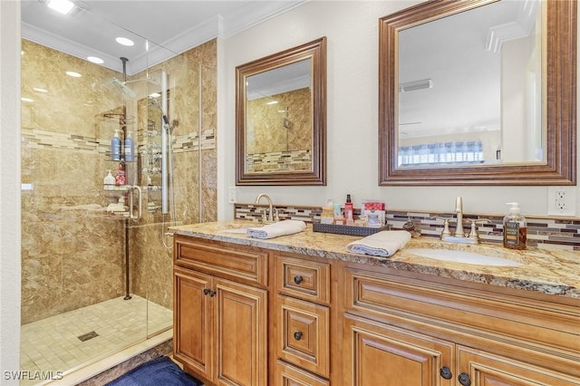 bathroom with a shower stall, ornamental molding, and a sink