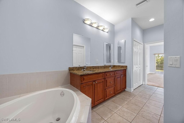 bathroom featuring double vanity, tile patterned flooring, a sink, and visible vents