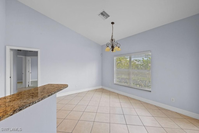 unfurnished dining area with light tile patterned floors, high vaulted ceiling, visible vents, baseboards, and an inviting chandelier