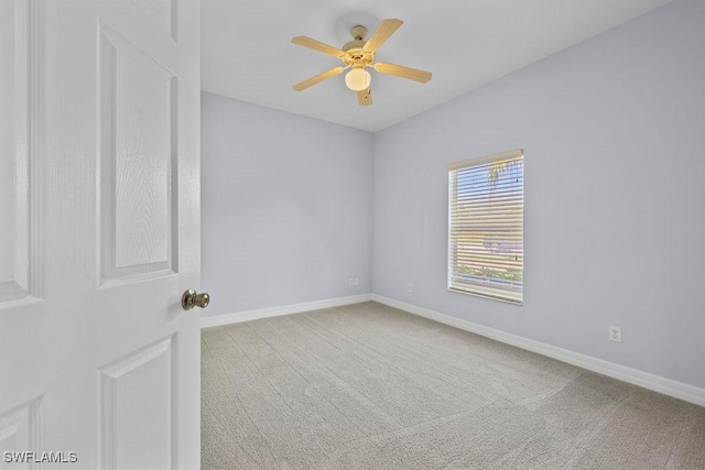 unfurnished room with a ceiling fan, carpet flooring, and baseboards