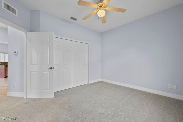 unfurnished bedroom featuring visible vents, light carpet, and baseboards