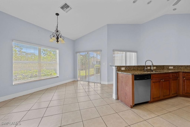 kitchen with brown cabinets, visible vents, stainless steel dishwasher, a sink, and dark stone counters