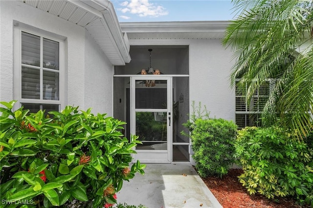 property entrance featuring stucco siding