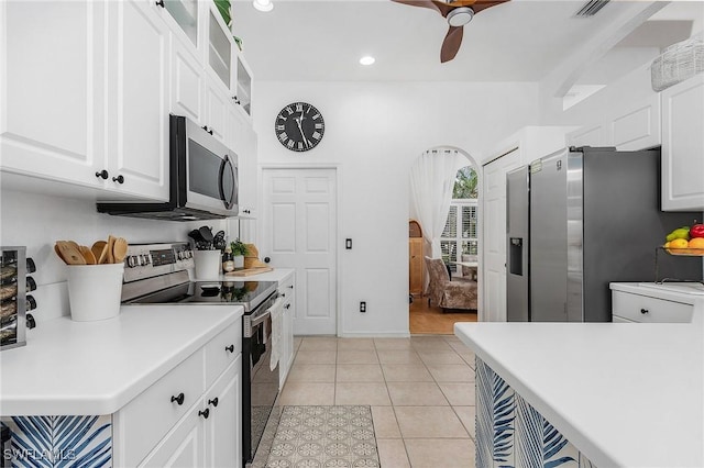 kitchen featuring ceiling fan, light tile patterned flooring, white cabinets, light countertops, and appliances with stainless steel finishes