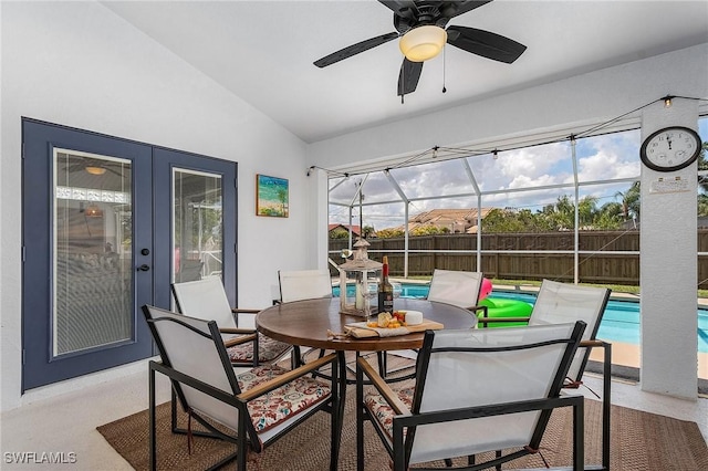 sunroom / solarium with a ceiling fan, lofted ceiling, and french doors