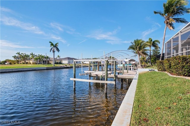 view of dock with a water view, a yard, and boat lift