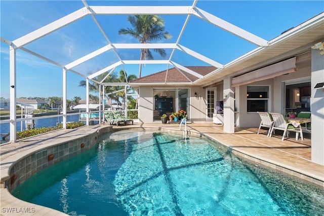 outdoor pool with a lanai, a patio area, and a water view