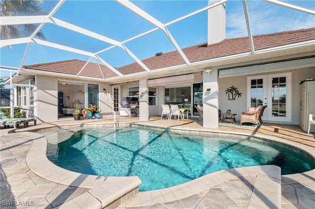 pool with a lanai, french doors, and a patio