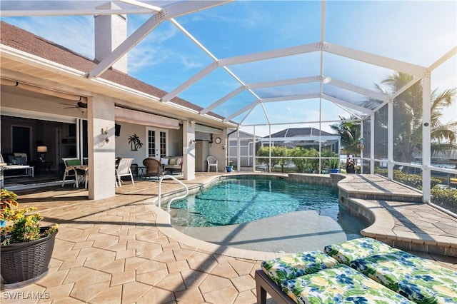 pool with a lanai, a patio, and ceiling fan