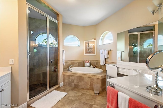 full bathroom featuring tile patterned floors, a garden tub, vanity, and a shower stall