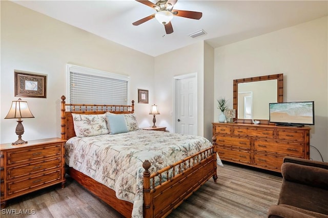 bedroom featuring ceiling fan, dark wood-type flooring, and visible vents