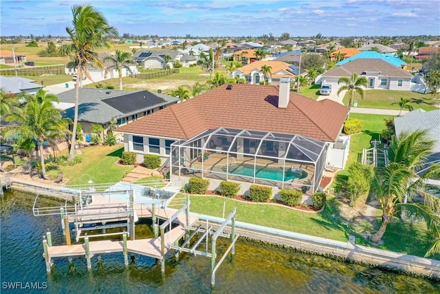 birds eye view of property featuring a residential view and a water view